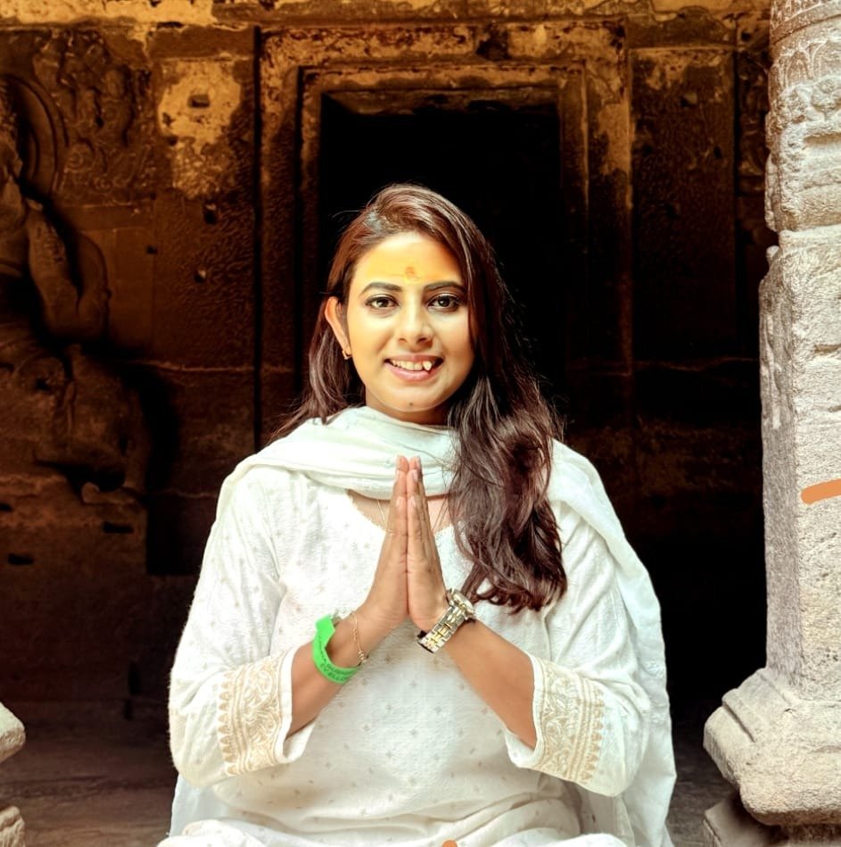 Coach Simantine Pramanick in yoga namaste pose